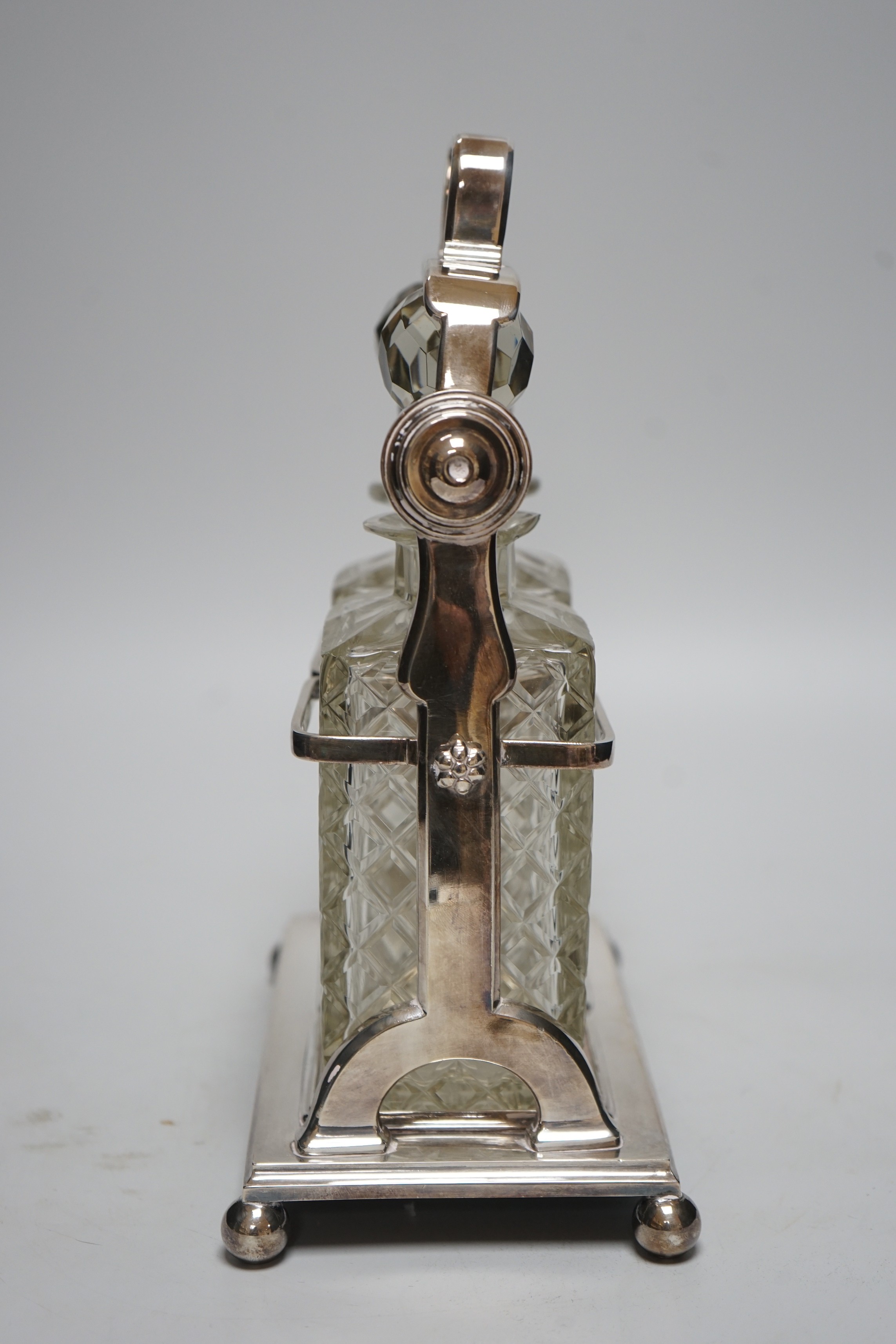 A plated tantalus with two bottles